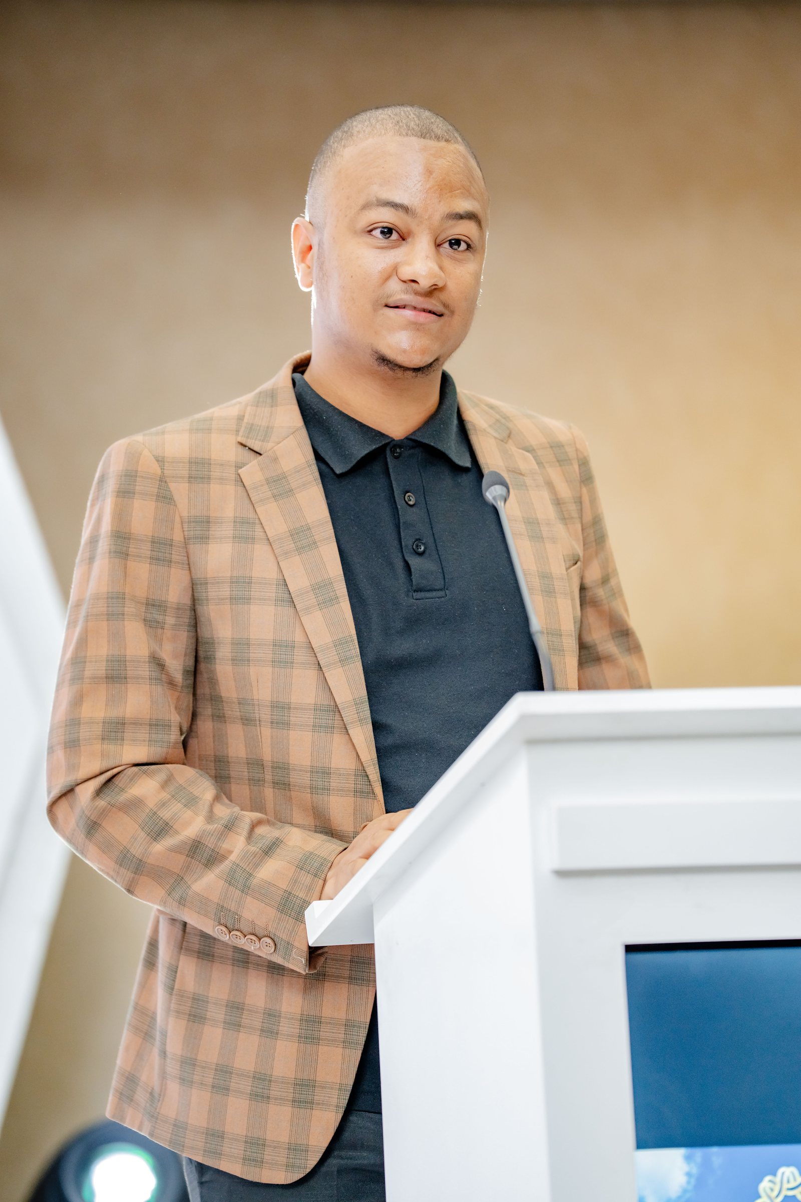 Maverick Kabelo speaking at the lectern