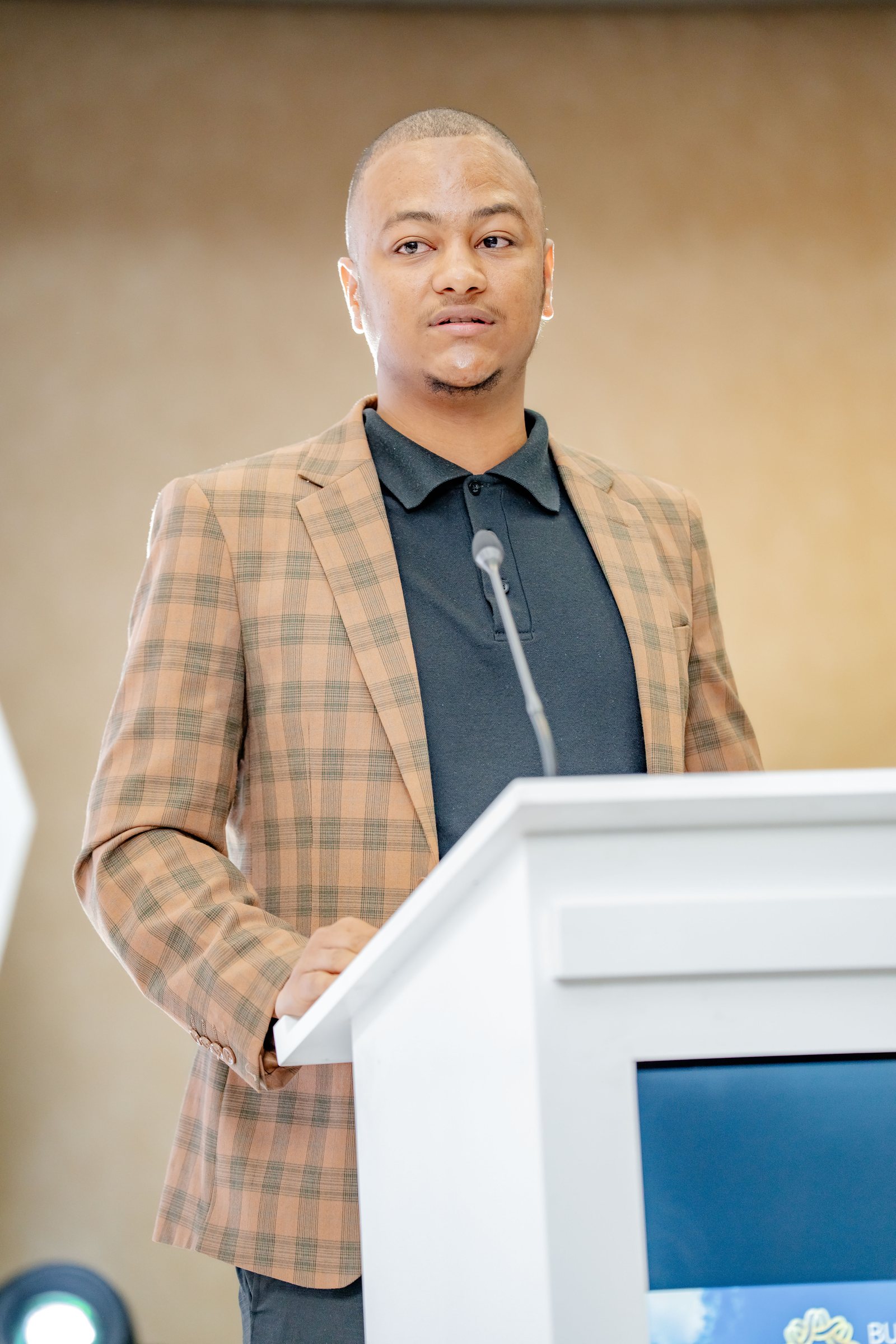 Maverick Kabelo speaking at the lectern