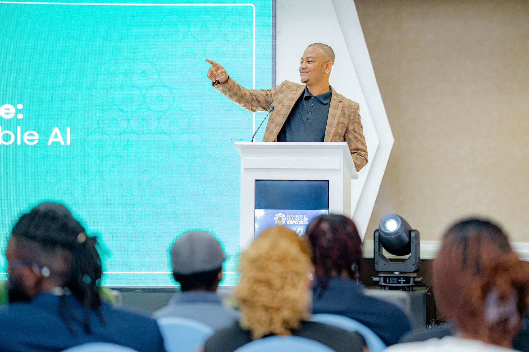 Maverick Kabelo gesturing toward the AI slide from a different angle