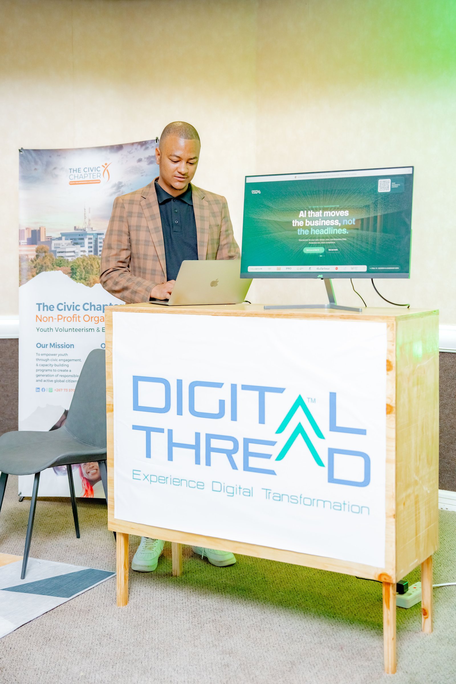 Maverick Kabelo at the Digital Thread booth with his laptop