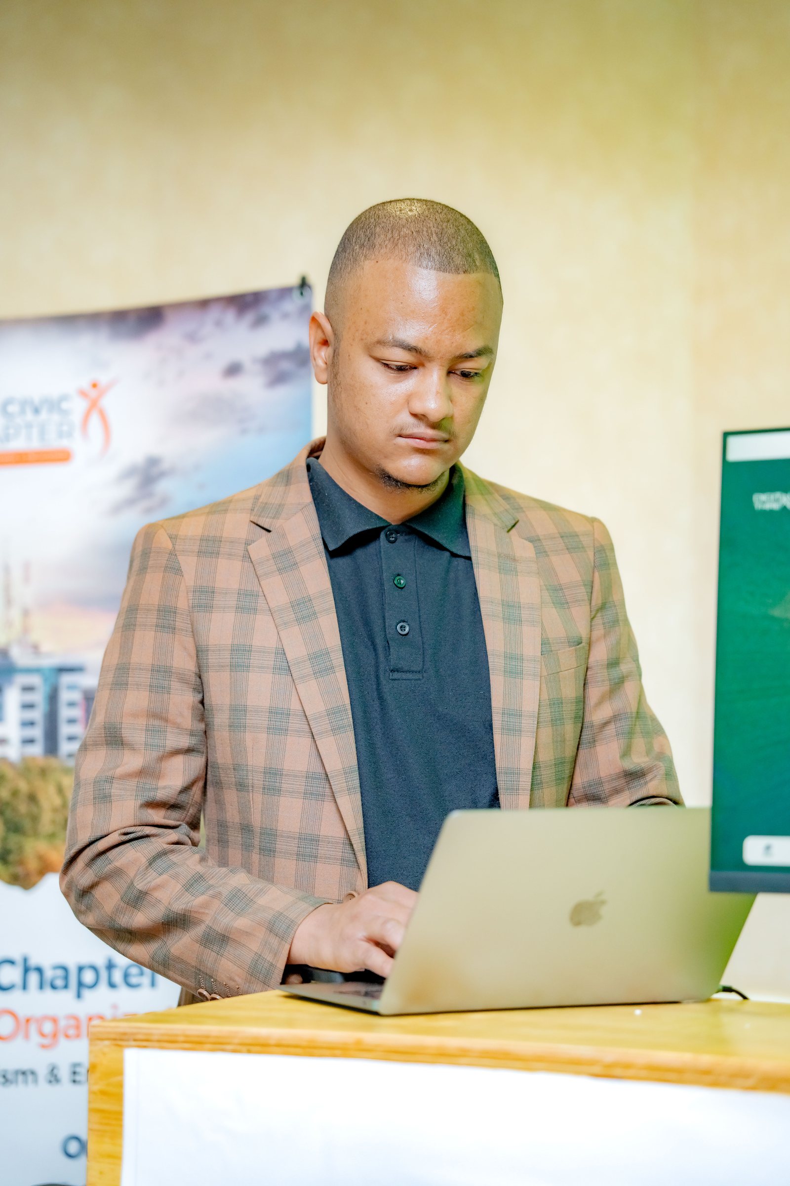 Maverick Kabelo working on his laptop at the Digital Thread booth