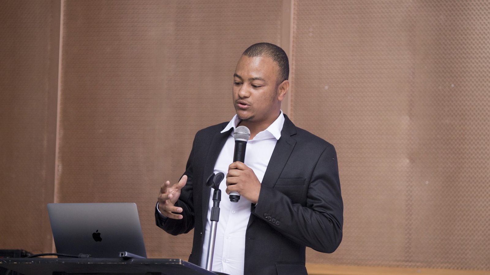 Maverick Kabelo speaking at the lectern at the Business & Leadership Expo, Northern Edition