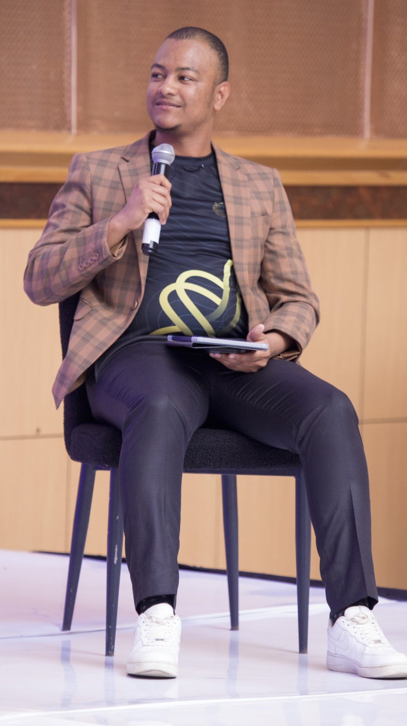 Maverick Kabelo seated on stage at the Business & Leadership Expo, Northern Edition